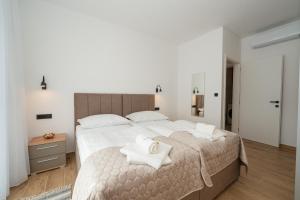 a bedroom with a large bed with towels on it at Villa Meritus in Gramače +67 photos