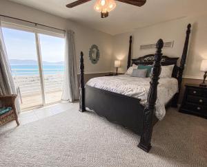 a bedroom with a bed and a large window at Updated Lake View Condo 941 2- Amazing Views in Garden City +40 photos