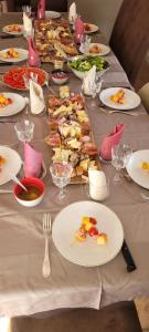 a long table with plates of food on it at Clos De La Ronziere Avec Jacuzzi in Soulages +28 photos