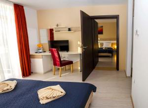 a bedroom with a bed and a desk with a computer at Hotel Pallone in Balatonfüred