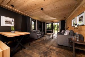 a living room with a couch and a table at Hotel Arc-en-ciel Gstaad in Gstaad