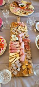 a table with many different types of meats and cheese at Clos De La Ronziere Avec Jacuzzi in Soulages