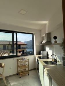 a kitchen with a sink and a large window at Lindo Verde T1 in Ventosa