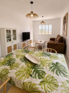 a bedroom with a large bed with a tropical print at Los cántaros Apartamento Mojácar in Mojácar