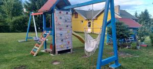 a playground with a slide and a climbing frame at Dovolenkový dom in Klokočov
