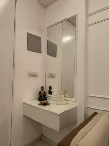two dolls sitting on a counter in front of a mirror at Skylines Zirakpur in Zirakpur