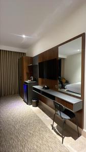a hotel room with a desk and a mirror at نون Noon in Medina