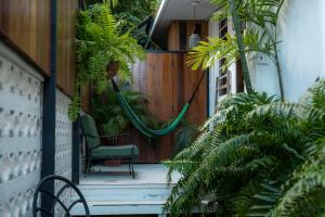 a porch with a hammock and plants at Casa Botanica in San Juan