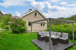 a backyard with a wooden deck with a gazebo at Lobrothaugen in Fagernes