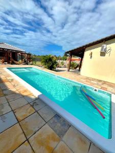 a large swimming pool in a house at Loft Azul - Pousada Vila Dondom in Luis Correia