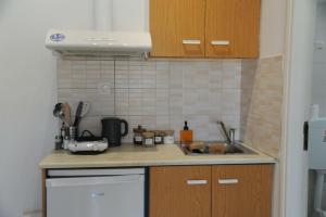 a kitchen with a sink and a counter top at MR RedNikos in Sellía +7 photos