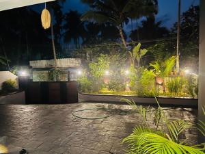 a garden at night with lights at South Elegance in Tellicherry