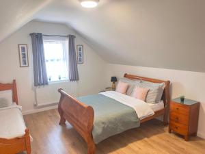 a bedroom with a bed and a window at Bundoran Holiday Letting in Bundoran