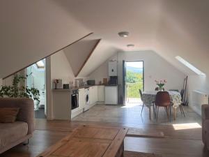 a living room with a table and a kitchen at Bundoran Holiday Letting in Bundoran