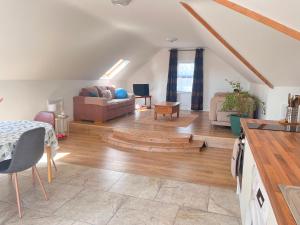 a living room with a couch and a table at Bundoran Holiday Letting in Bundoran