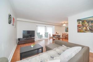 a living room with a couch and a tv at Finch Terminal Station 1min -Yonge and Finch Intersection in Toronto