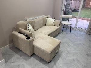 a living room with a couch and a table at One Bedroom Spacious House in Cardiff