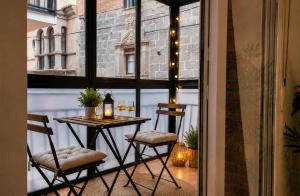 a small balcony with a table and two chairs at Apartamento Premium Ávila PLAZA MAYOR con PARKING in Ávila
