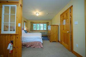 a small bedroom with a bed and a window at 148 Divot Simcoe Cottage private Beach, Kayak in Georgina