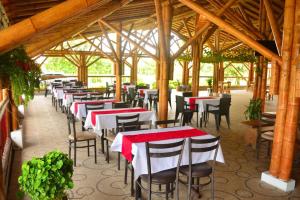 a row of tables and chairs in a restaurant at Finca Hotel Loma del Café in Pueblorrico