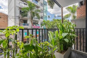 a balcony with plants in front of a building at Park 38 in Envigado
