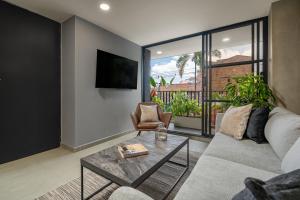 a living room with a couch and a table at Park 38 in Envigado