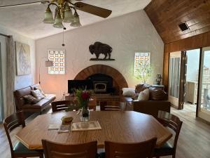 a living room with a table and a fireplace at Wolf Den retreat on 20 acres in Julian