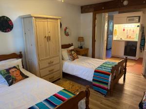 a bedroom with two beds and a dresser at Wolf Den retreat on 20 acres in Julian