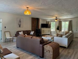 a living room with two couches and a tv at Wolf Den retreat on 20 acres in Julian