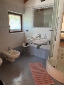 a white bathroom with a sink and a shower at Agriturismo Le Cavade in Cembra +65 photos