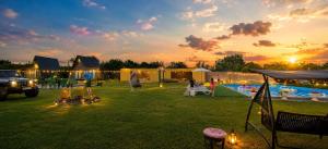 a group of people in a yard with a pool at Green Village in Grigolaantkari