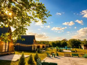 a park with benches and a building with lights at Green Village in Grigolaantkari