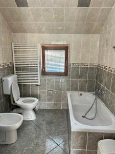 a bathroom with a toilet and a tub and a sink at Hajr Villa in Ilidža +38 photos