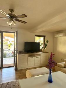 a living room with a flat screen tv and a couch at Hajr Villa in Ilidža