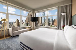 a hotel room with a large bed and a large window at ModernHaus SoHo in New York +69 photos