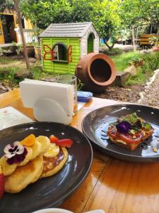 two plates of food on a wooden table at Pakakuna in Urubamba