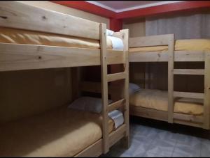 a couple of bunk beds in a room at Pakakuna in Urubamba