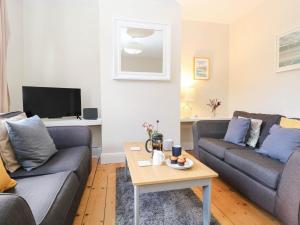 a living room with two couches and a coffee table at 19 Covert Road in Southwold
