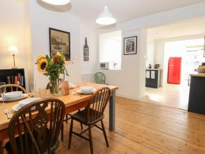 a kitchen and dining room with a table and chairs at 19 Covert Road in Southwold