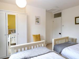 a bedroom with two beds and a closet at 19 Covert Road in Southwold