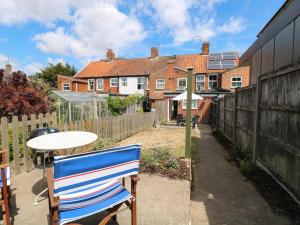 a patio with a table and chairs and a house at 19 Covert Road in Southwold