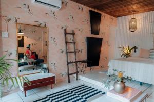 a bedroom with a pink wall with birds on it at Casa Botanica in San Juan +150 photos