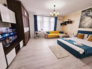 a bedroom with a bed and a living room at Central Bucharest 1-Bedroom Apartment near Universitate Metro in Bucharest