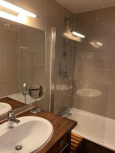 a bathroom with a sink and a shower and a tub at Tania nice chalettt garden view in Courchevel +21 photos