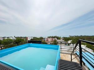 a swimming pool on the roof of a building at La Couronne Seaview Resort in Pondicherry