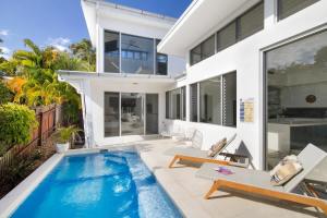 a swimming pool in the backyard of a house at Stunning Views, Private Pool Near Hastings St in Noosa Heads