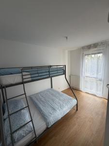 a bedroom with two bunk beds and a window at Modern 2BR Train, Versailles, Paris in Plaisir