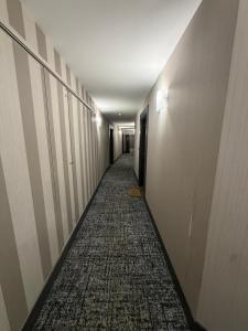 a corridor of a hallway with a long hallway at Modern 2BR Train, Versailles, Paris in Plaisir