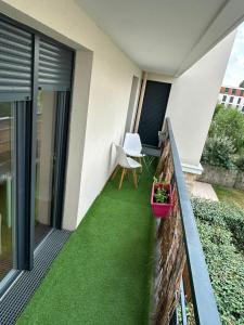 a small balcony with green grass on a house at Modern 2BR Train, Versailles, Paris in Plaisir