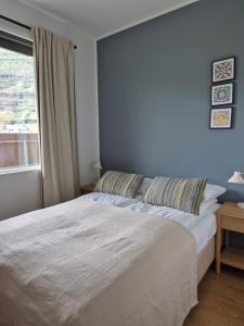 a bedroom with a large bed and a window at Seydisfjördur Apartment in Seyðisfjörður